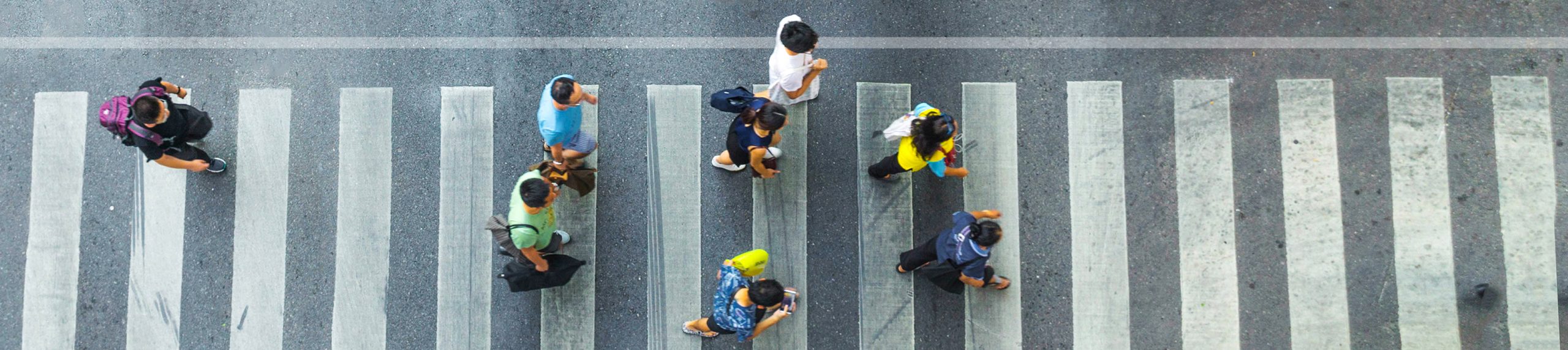 the one man walk converse,  the busy city crowd move to pedestrian crosswalk on businees traffric road (Aerial photo, top view)